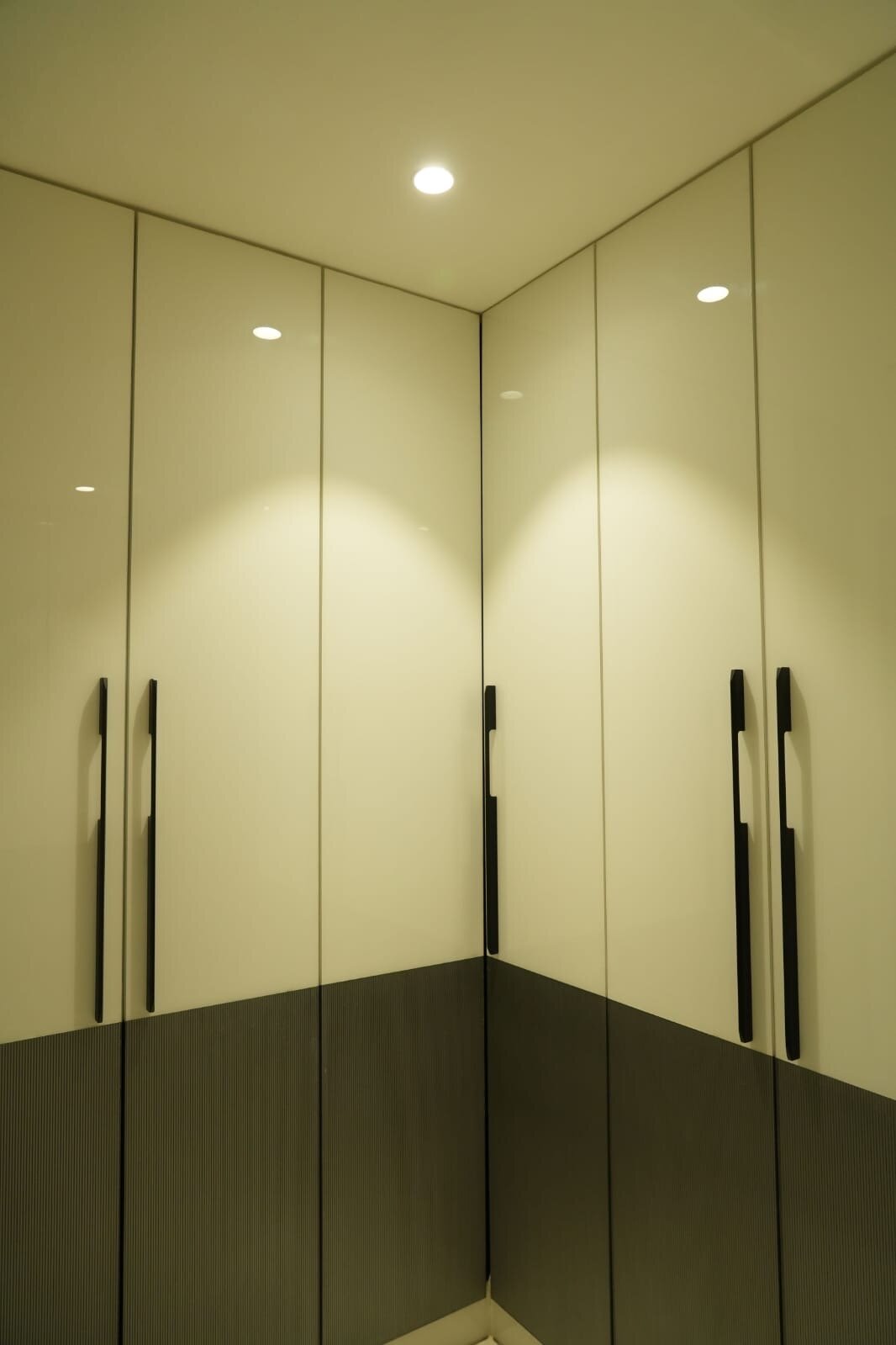 Contemporary built-in wardrobe with two-tone design and LED lighting