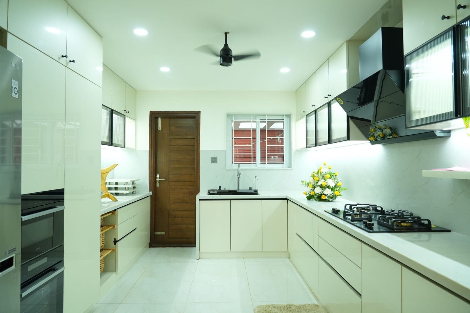 Modern kitchen with cream cabinetry and marble countertops