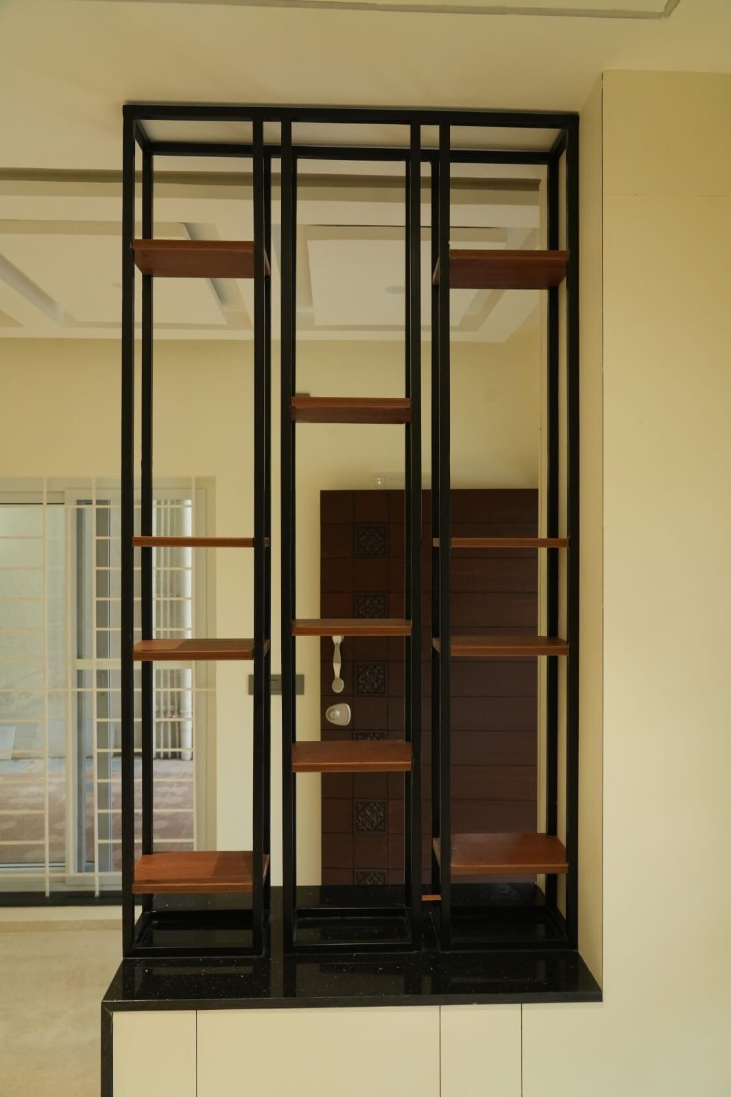 Elegant room divider with wooden shelves and modern metal frame