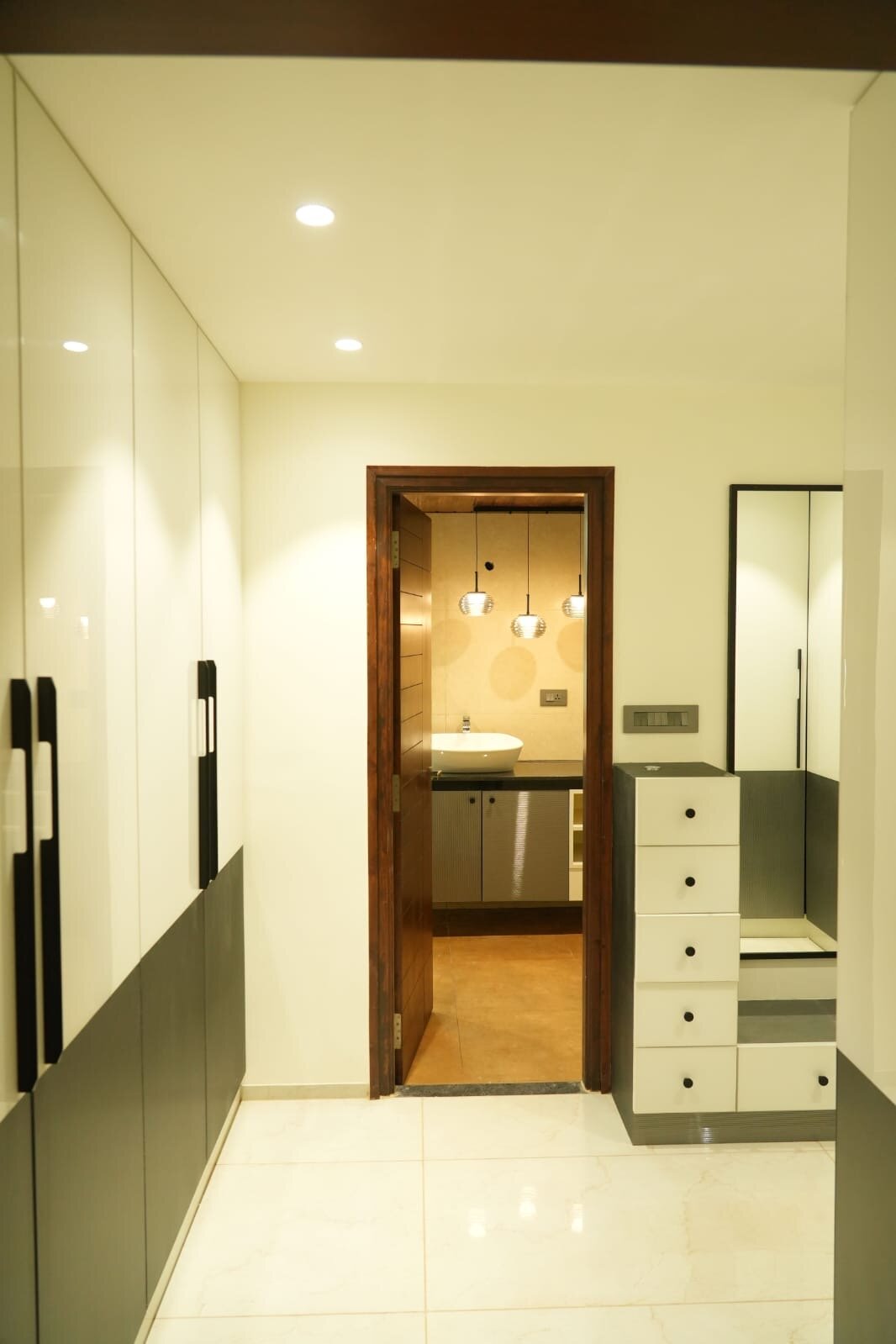 Contemporary hallway with built-in storage and modern bathroom entrance