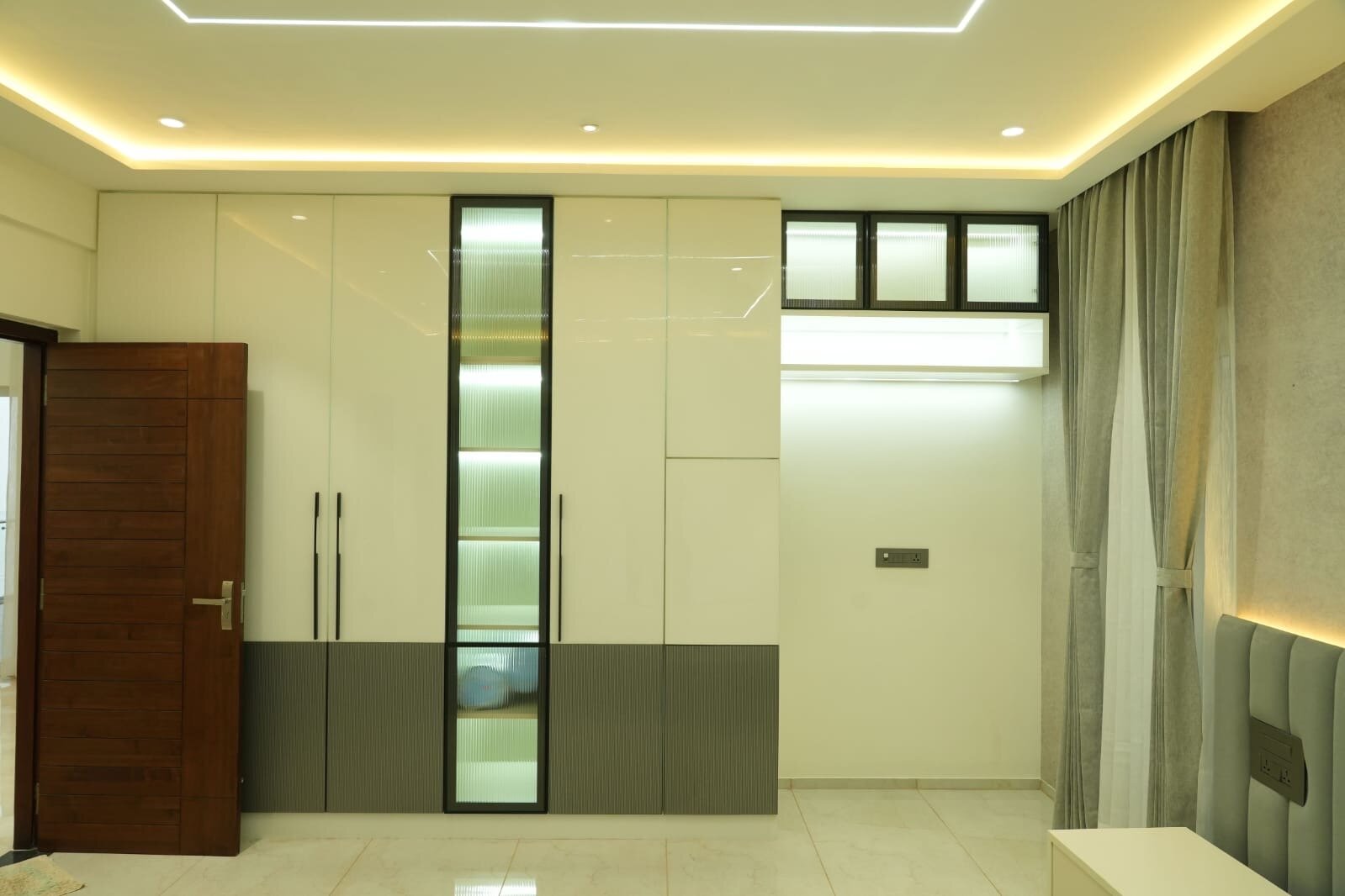 Modern living room with floor-to-ceiling windows and elegant curtains