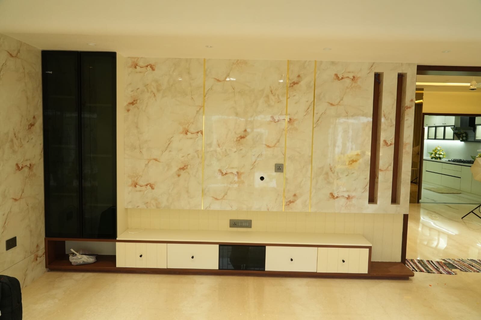 Contemporary kitchen cooking area with black gas stove and range hood